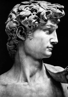 a black and white photo of a bust of a man with curly hair