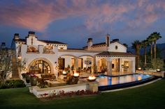 a large house with a pool in front of it