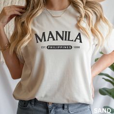 Manila Philippines Shirt, Manila Sweatshirt, Manila Filipino Shirt, Filipino University Student Shirt, Travel Shirt Filipino Patriotic Shirt Explore the fusion of heritage and style with our Manila Sweatshirt - a unisex, travel-inspired gem perfect as a gift for him or her. Represent Manila, Philippines in this college-style, Filipino American Sweatshirt, a proud emblem for every Filipino student or Philippines enthusiast. Showcase your Filipino pride with our Manila Philippines Shirt - a travel-inspired, Manila Sweatshirt designed for the globally-minded. This Manila Filipino Shirt, ideal for Filipino University Students, harmonizes patriotic flair and comfort in one unique, wearable statement. Summary of the product: Ideal for any situation, a unisex heavy blend crewneck sweatshirt is pu Casual Everyday Tops With Name Print, Everyday Crew Neck Top With Name Print, Casual Relaxed Fit Shirt With Name Print, Casual Cotton Shirt With Name Print, Trendy Crew Neck Shirt With Name Print, Casual Long Sleeve Shirt With Name Print, Graphic Tee Shirt With Name Print In Relaxed Fit, Relaxed Fit Graphic Tee With Name Print, Filipino Pride