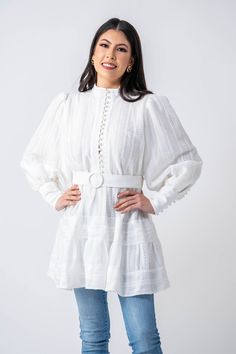 DESIGNED WITH YOU IN MIND Ameera Modest Wear is proud to present our Algarve tunic that screams versatility and elegance. We promise our Algarve tunic will be a hot new addition to your wardrobe! This women's high neck tunic has been carefully constructed from a delicately trimmed lace with a light linen lining, leaving it comfortable and breathable while still looking incredibly modest and feminine. The material gathers at the waist with a buckled belt for a flattering look on all body types. T Chic White Long Sleeve Tunic, White Long Sleeve Tunic For Day Out, Lace Tunic, Modest Wear, Algarve, Cotton Lace, Body Types, Snow White, High Neck