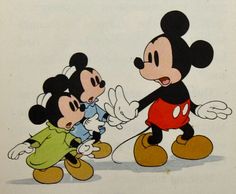 two mickey mouses playing with each other on a white sheet that has been drawn