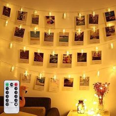 a living room filled with furniture and pictures hanging on the wall above it's lights