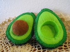 an avocado shaped object sitting on top of a doily