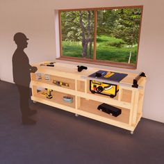 a man standing next to a workbench in front of a window with tools on it