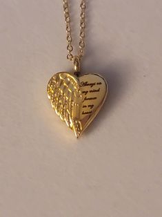 Gold Heart with Angel Wing Cremation Urn says Always On My Mind, Forever In My Heart.  Necklace comes with everything needed to help you get the ashes into the urn.  ** We also have this necklace available in silver.  Heart urn is stainless steel and comes on a 20inch gold stainless steel chain.  To personalize this necklace please check out our "ADD On" section.  Simply go to the search bar on our shop's homepage.   Once there type "Add On" into the search bat.  If you find anything you like you can add it to your cart along with this necklace.   Once everything is in your cart you can select "purchase" to make your purchase.  Please feel free to message us with any questions you may have.   We would be happy to help you.  Thank you so much. Meaningful Heart-shaped Keepsake Necklace, Personalized Heart Shaped Spiritual Necklace, Personalized Heart-shaped Spiritual Necklace, Inspirational Gold Heart Jewelry, Inspirational Heart-shaped Gold Jewelry, Heart Shaped Necklaces For Valentine's Day Commemoration, Heart-shaped Necklaces For Valentine's Day Commemoration, Heart-shaped Necklace For Valentine's Day Commemoration, Heart Necklace For Valentine's Day Commemoration