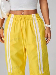 Style:Casual \nClosure Type:Elastic Waist \nDetails:Pocket \nDetails:Tape \nDetails:Side Stripe \nColor:Yellow \nPattern Type:Colorblock \nPattern Type:Striped \nType:Straight Leg \nWaist Line:Drop Waist \nLength:Long \nFit Type:Loose \nFabric:Non-Stretch \nMaterial:Woven Fabric \nComposition:100% Polyester \nCare Instructions:Machine wash or professional dry clean \nPockets:Yes \nTemperature:Spring/Fall (18-25℃/63-77℉) \nBody:Unlined \nSheer:No \n Trendy Streetwear, Women Pants, Side Stripe, Color Stripes, Drop Waist, Long Pants, Bright Color, Summer Women, Contrasting Colors