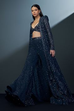 Navy blue high-low jacket featuring cutwork mesh geometric patterned base embellished with crystals and beads. Comes with matching embellished blouse and mesh patterned bead-crystal embellished sharara. - Aza Fashions Elegant Blue Designer Outerwear, Festive Party Outerwear With Dupatta, Blue Long Sleeve Choli For Party, Elegant Blue Outerwear With Zari Work, Blue Long Sleeve Embellished Choli, Festive Blue Party Outerwear, Fitted Bollywood Party Outerwear, Fitted Bollywood Outerwear For Party, Bollywood Style Fitted Party Outerwear