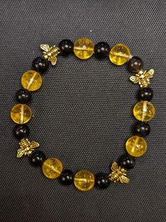 10mm yellow citrine, 8 mm black agate, small golden bee beads. Silver bee beads also available.  Very cute. I can customize it to your wrist size.  To wear: please roll a stretchy bracelet over your hand, pushing it gently on to the wrist. Pulling it may loosen the thread over time. The exact pattern of black and yellow may vary slightly based on your bracelet size. Gift box available. Bee Beads, Grey Bracelet, Bee Bracelet, Gray Bracelet, Yellow Citrine, Black Agate, Stretchy Bracelets, Stretch Bracelet, Bracelet Sizes