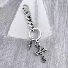 a key chain that has a cross on it