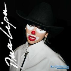 a woman with white makeup and clown make - up on her face wearing a black hat