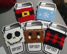 four cup cozys are sitting on a table