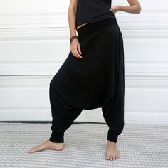 "Black Samurai Style Ninja Pants for Women and Men. This Stretch Cotton Harem Pants Fit Plus Size. -Unisex -Stretch -Flowing relaxed fit -Inner drawstring to secure the waist -2 side pockets Great for Yoga, Dance, Exercises, Meditations, Yoga Practice and beyond... Materials: black color cotton blend (90% cotton 10% lycra). Fabric for this pair were bought in Fashion District, LA and the pant was made in one of the studios in Los Angeles, CA. Measurements: Fits: S, M, M/L -Length: 41\" (~102 cm) Casual Black Yoga Bottoms, Black Sweatpants For Yoga, Baggy Black Tapered Leg Harem Pants, Black Ankle-length Sweatpants For Yoga, Black Harem Pants With Elastic Waistband And Tapered Leg, Black Tapered Leg Loungewear Pants, Black Wide Leg Sweatpants For Yoga, Black Wide-leg Sweatpants For Yoga, Black Full-length Yoga Pants