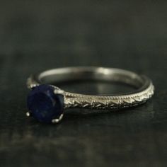 "Lapis Lazuli Ring Full Cut Lapis Ring Blue Engagement Ring Antique Style Ring Sterling Silver Alternative Engagement Ring Blue Jeans Looking for your bride's \"something blue\"? Look no further than our Lapis Lazuli solitaire \"Blue Jeans\" ring. This traditional setting is modernized with a full cut 6mm Lapis Lazuli stone. Its name comes from the Latin lapis, \"stone,\" and the Persian lazhuward, \"blue.\" It is said to help bring inner peace and clear one's mind from negative thought patterns Sapphire Diamond Cut Promise Ring Jewelry, Stackable Sapphire Ring For Promise, Classic Royal Blue Round Sapphire Ring, Blue Birthstone Promise Ring Stackable, Blue Stackable Birthstone Ring For Promise, Elegant Blue Stackable Jewelry, Classic Blue Stackable Jewelry, Sapphire Jewelry With Diamond Cut In Round Band, Sapphire Diamond-cut Round Band Jewelry