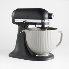 a black and white mixer on a white background with the bowl in it's center