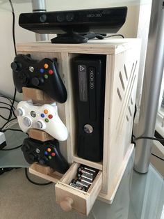 several video game controllers are stacked on top of each other in a wooden box,