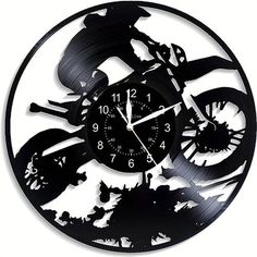 a clock that is made to look like a motorcycle rider on a bike in the air