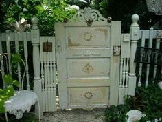 an old white cabinet sitting in the middle of a garden