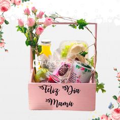 a pink box filled with lots of different types of items next to flowers and leaves