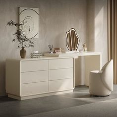 a white dresser sitting next to a mirror on top of a wooden table in a room