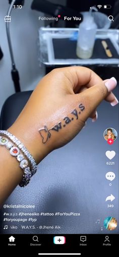 someone is holding their hand up with the word always tattooed on her left arm and wrist