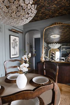 a dining room table with white flowers on it