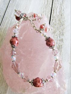 "These ROSE CERAMIC BEADS almost look like STONE! The color is so rich and the variations just beautiful! SO skillfully made! The ceramic beads (4 of them) are 10x14mm, along with clear and blush crystals, soft rose colored glass bicones, and some Czech glass. The bracelet adjusts from 6.5\" to 7.5\" in length and secures with a lobster clasp. I can lengthen/shorten somewhat upon request. The beadcaps, spacers, findings, chain and clasp are pewter and silver plate. I LOVE the colors and the way Adjustable Pink Bracelets, Adjustable Hypoallergenic Crystal Bracelet, Useable Gifts, Ceramic Beads Bracelet, Tote Outfit, Farmers Market Bag, Free Gift Tags, Soft Rose, Fitness Bracelet