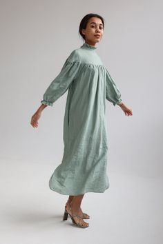 "Linen elegant dress with long wide sleeves, no shoulder line and delicate ruffle at the neck has tie detail in the back. Wide sleeves shrink with elastic at the bottom. Loose cut dress is comfy yet elegant and can be worn for various occasions. You can wear it without belt for romantic and free style or use belt to create more classic look. Belt is long enough to go around waist twice! For more chic look, style it with accessories. Double washed for extra softness and shrinkage prevention. ABOU Spring Ruffled Maxi Dress For Gatherings, Linen Ruffle Dress For Daywear, Feminine Linen Midi Dress With Ruffles, Elegant Linen Dresses With Ruffles, Summer Linen Long Sleeve Dress For Garden Party, Daywear Puff Sleeve Dress With Ruffles, Bishop Sleeve Puff Dress With Ruffles For Daywear, Spring Daywear Dress With Ruffled Collar, Elegant Ruffled Prairie Dress For Fall