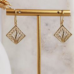 Elevate your style with our Aesthetic Filigree Square Dangle Earrings, a blend of bohemian charm and timeless elegance. These unique earrings feature intricate filigree work in a square dangle design, crafted in gold-plated metal. Measuring approximately 18mm in width (about 3/4 inch) and 30mm in length (about 1 3/16 inches), they offer a striking look that's perfect as a unique gift or for adding a minimalist touch to any outfit." ✓ Bohemian Charm: Intricate filigree square dangle design. ✓ Gol Elegant Hypoallergenic Rectangular Jewelry, Elegant Rectangular Hypoallergenic Jewelry, Elegant Square Pendant Earrings As Gift, Elegant Nickel Free Square Pendant Earrings, Elegant Rectangular Filigree Jewelry, Elegant Gold Square Earrings, Traditional Filigree Drop Earrings, Gold Rectangular Filigree Jewelry, Antique Gold Filigree Dangle Earrings