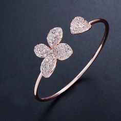 Formal Rose Gold Flower Bracelet, Elegant Rose Gold Flower Crystal Bracelet, Rose Gold Cubic Zirconia Bangle, Dazzling Rose Gold Cubic Zirconia Bracelet, Elegant Sparkling Rose Gold Bracelet, Sparkling Diamond Bracelets In Rose Gold, Rose Gold Cubic Zirconia Bangle Bracelet, Rose Gold Cubic Zirconia Flower Jewelry, Rose Gold Flower Cubic Zirconia Jewelry