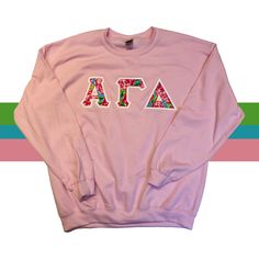 Pink Crew Neck Top With Letter Print, Pink Long Sleeve Top With Letter Embroidery, Pink Crew Top For Fall, Spring Pink Sweatshirt With Embroidered Graphics, Pink Winter Sweatshirt With Embroidered Graphics, Winter Pink Sweatshirt With Embroidered Graphics, Pink Embroidered Sweatshirt For Spring, Pink Long Sleeve Sweatshirt With Embroidered Text, Long Sleeve Pink Top With Embroidered Text