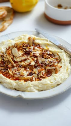 a white plate topped with mashed potatoes covered in toppings