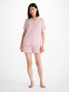 Perfect for lounging in when you get home from work, a good night's sleep and then breakfast round the table in the morning - our ballet pink Lara jersey shortie pyjamas work effortlessly as a versatile modern take on the classic pyjama. Designed for a flattering but comfortable shape, our women's shortie pyjamas will keep you looking great and feeling comfortable throughout the seasons. The short sleeve jacket top features a fully piped finish in a contrasting white piping for a stylish appeara Pink Short Length Sleepwear For Loungewear, Pink Short Length Sleepwear For Lounging, Feminine Pajama Shorts For Loungewear, Short Length, Feminine Pajama Shorts For Loungewear, Feminine Loungewear Pajama Shorts, Feminine Short Sleepwear For Pajama Party, Feminine Short Length Pajama Shorts For Loungewear, Pink Pajama Shorts For Relaxation, Pink Pajama Shorts For Daywear