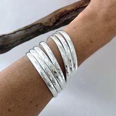 This stunning and elegant set of 7 bangles are individually handmade in Mexico.Handcrafted to the highest quality from 6mm solid half round wire, hammered by hand, they are polished and silver plated.They make a lovely tune when they jangle together!The Semanario (7 day bracelet) is an very traditional Mexican gift, they symbolize each day of the week.The bangles are 8" inches in circumference and 2.5" inches in diameter. If you've got any questions don't hesitate to ask me.These bangles come gi Cheap Silver Festival Bangle, Cheap Hypoallergenic Bangle Bracelets, Cheap Sterling Silver Bangle Jewelry, Luxury Heavy Silver Bangle, Affordable Silver Party Bangle, Cheap Silver Stackable Bangle, Cheap Sterling Silver Bangle Bracelets, Cheap Sterling Silver Bangle Bracelet, Affordable Handmade Bangle Bracelets