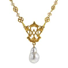 An ornate, openwork plaque with letters, accented by a filigree link chain stationed with fresh water pearls and finished with baroque pearl drop, pendant measures 1 3/4 inches long, fashioned in 18k yellow gold (tested) with 10k yellow gold clasp. Circa 1880. Length 16 inches. Classic Baroque Jewelry With Pearl Drop, Classic Baroque Pearl Drop Jewelry, Formal Baroque Pearl Necklace With Pearl Charm, Baroque Pearl Drop Necklace For Formal Occasions, Formal Baroque Pearl Necklace With Charm, Luxury Baroque Pearl Drop Jewelry, Formal Baroque Pearl Drop Necklace, Classic Baroque Pearl Necklace With Pendant, Gold Baroque Jewelry With Pearl Pendant