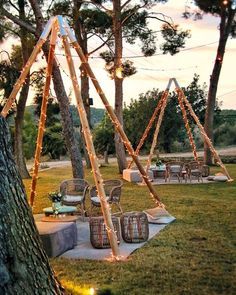 an outdoor seating area with lights strung from the trees