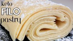 a pastry with powdered sugar on top and the words keto filo pastry