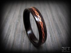 a wooden ring with an intricate design on it