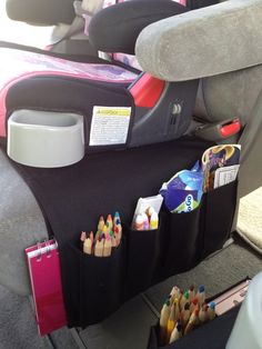 back seat organizer with crayons and pencils in it