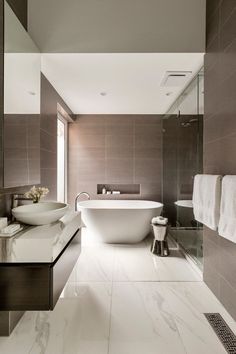 a bathroom with a large white tub next to a sink