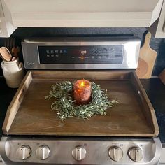 a candle is sitting on top of an oven