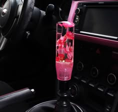 a car dashboard with pink flowers in the center