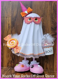 a white dress with pink shoes and a hat on it that says knock your socks off door decor