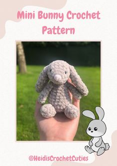 a small crocheted bunny sitting on top of a hand