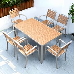 an outdoor table with six chairs around it