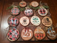 christmas ornaments made out of wood are hanging on a table