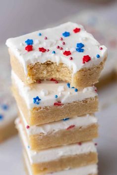 three pieces of cake with white frosting and red, white, and blue sprinkles