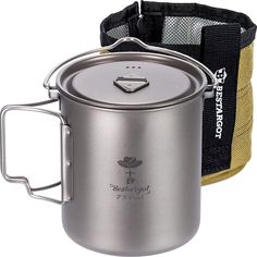 a stainless steel pot with a black strap around it and a yellow bag behind it