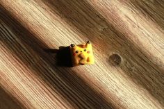 a small yellow object sitting on top of a wooden table