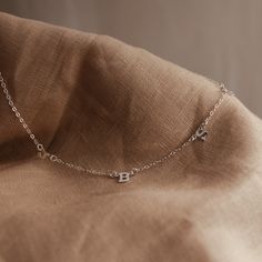 Our delicate Love Notes Necklace is a thing of exquisite beauty and meaning. Its subtly asymmetrical design evokes grace and refinement, while also carrying your most cherished people close to your heart. As we create our jewellery by hand, there will always be variation in alignment and spacing. The beauty of this process is that each KBN piece is unique to its wearer. Asymmetrical Necklace, Rectangle Necklace, Oval Necklace, Symbol Necklace, Zodiac Necklaces, Asymmetrical Design, Love Notes, Pure Gold, Gold Filled Jewelry