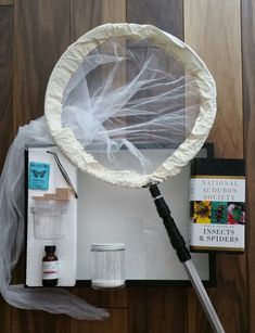 the contents of a crafting kit are laid out on a wooden surface, including an umbrella and other items